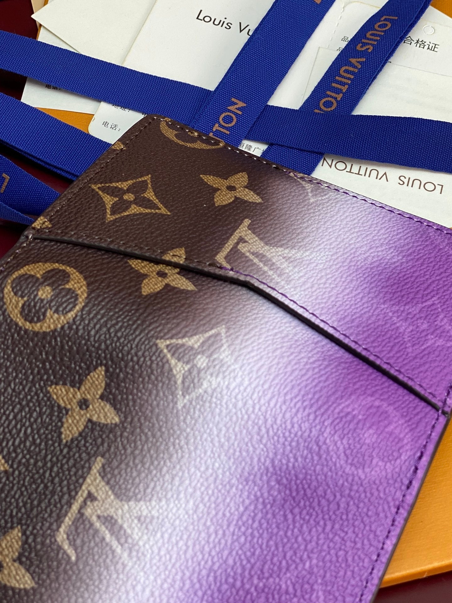 Small bag card holder detail: purple flap with brown monogram canvas overlay