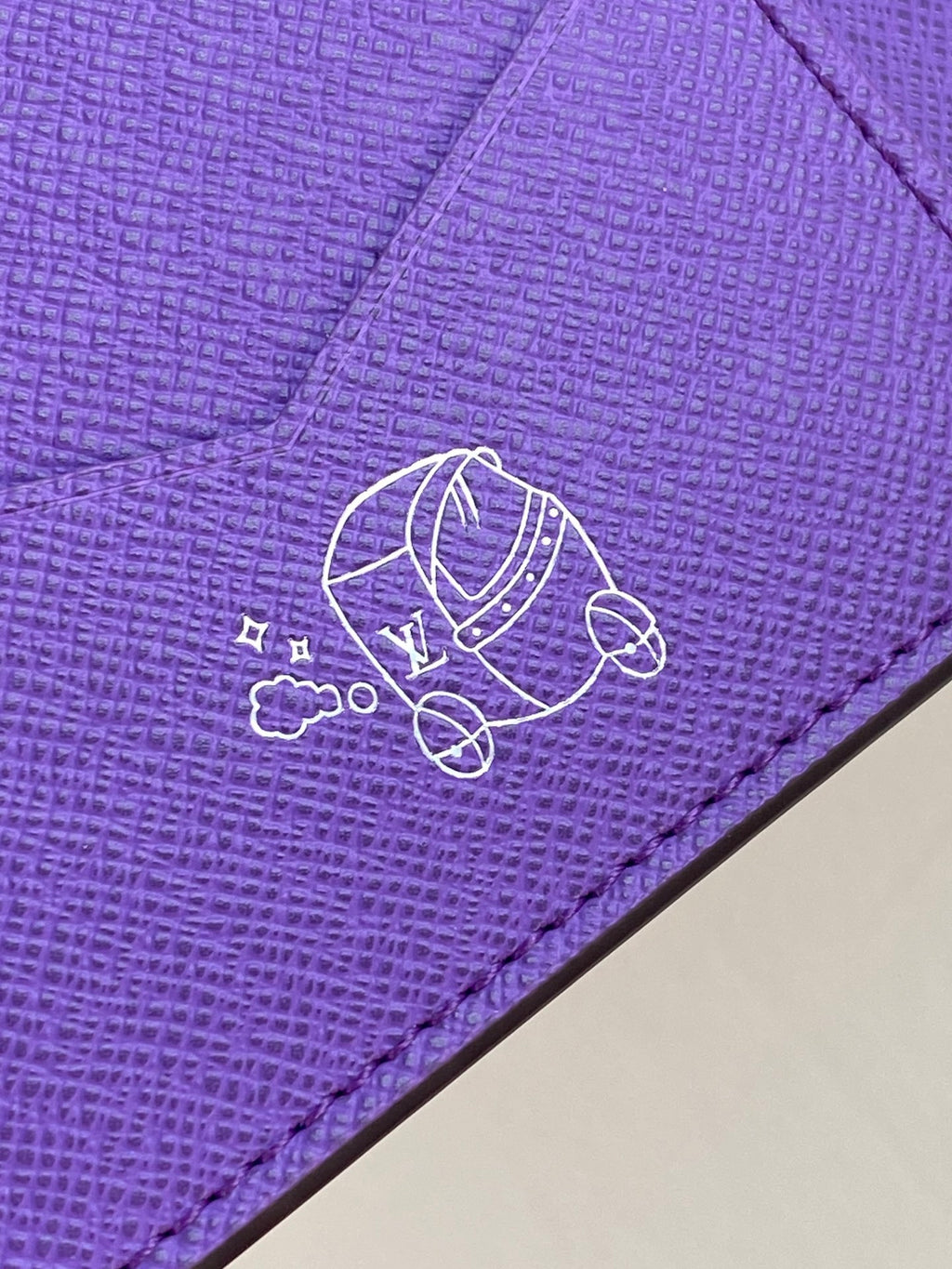 Purple small bag with Louis Vuitton line-art logo and bicycle graphic