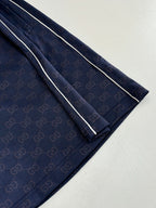 Navy patterned shorts with contrast side stripe and straight cut legs, close-up