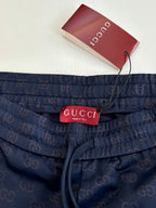 Navy shorts with elastic waist, drawstring, and Gucci label at center front