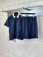 Navy patterned drawstring shorts with elastic waistband, hanging with matching top