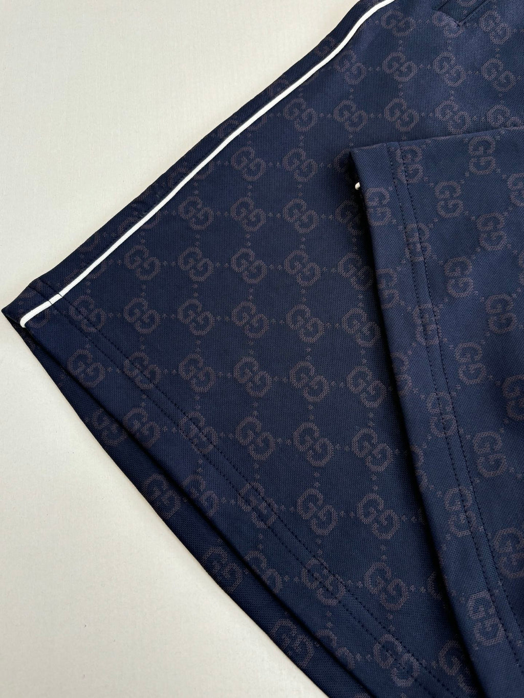 Navy patterned shorts with contrast side stripe and relaxed fit, close-up