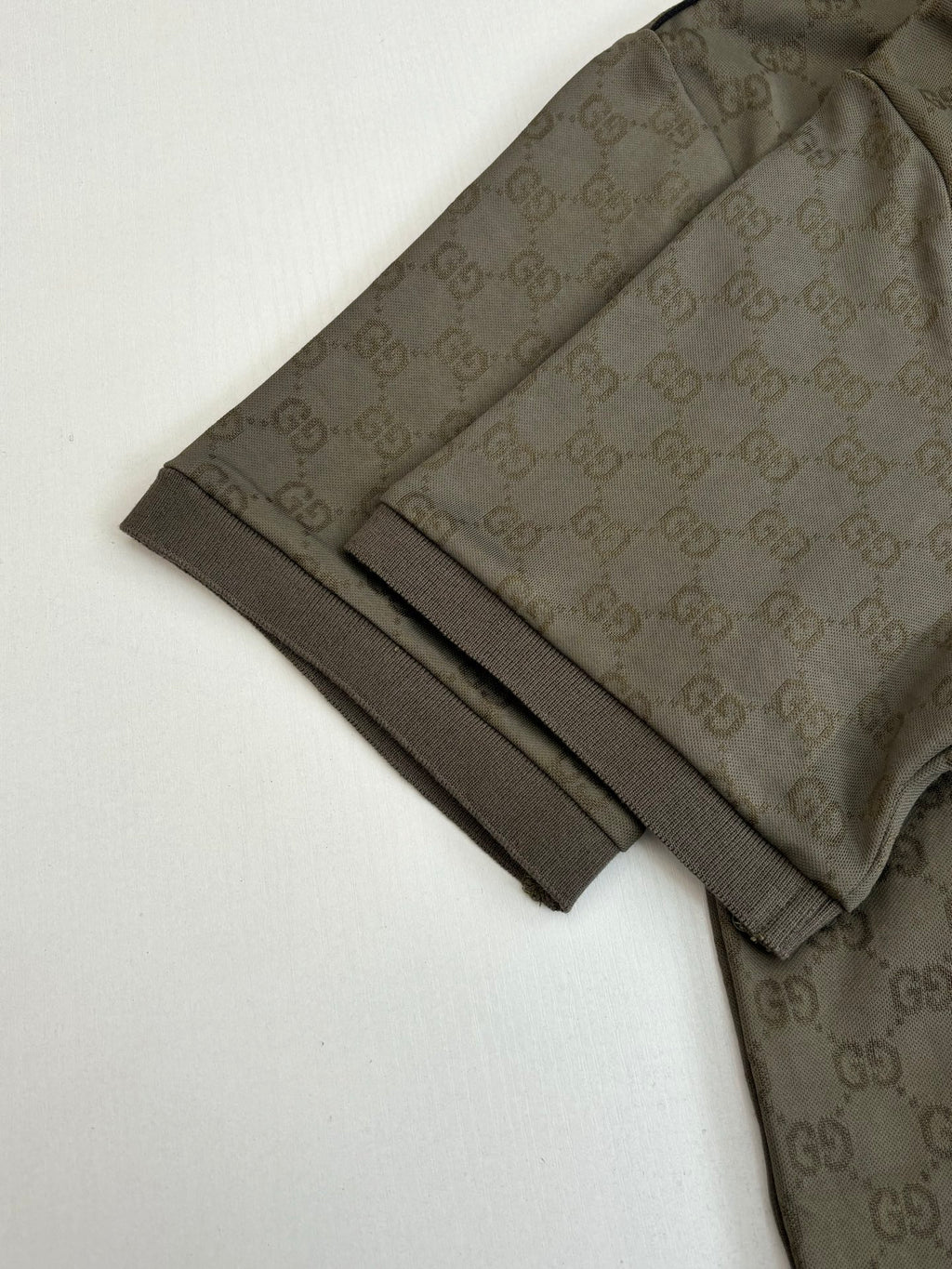 Gucci monogram shorts hem with dark olive fabric and black stripe detail