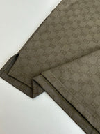 Gucci monogram shorts with dark olive side stripe and stitched hems, laid flat