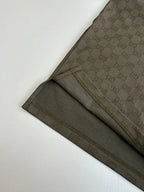 Gucci monogram shorts with dark olive fabric and side seam stripe, flat lay