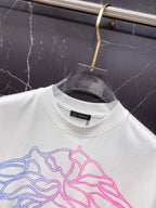 White T-shirt neckline with large blue and pink Medusa graphic, crew neck.