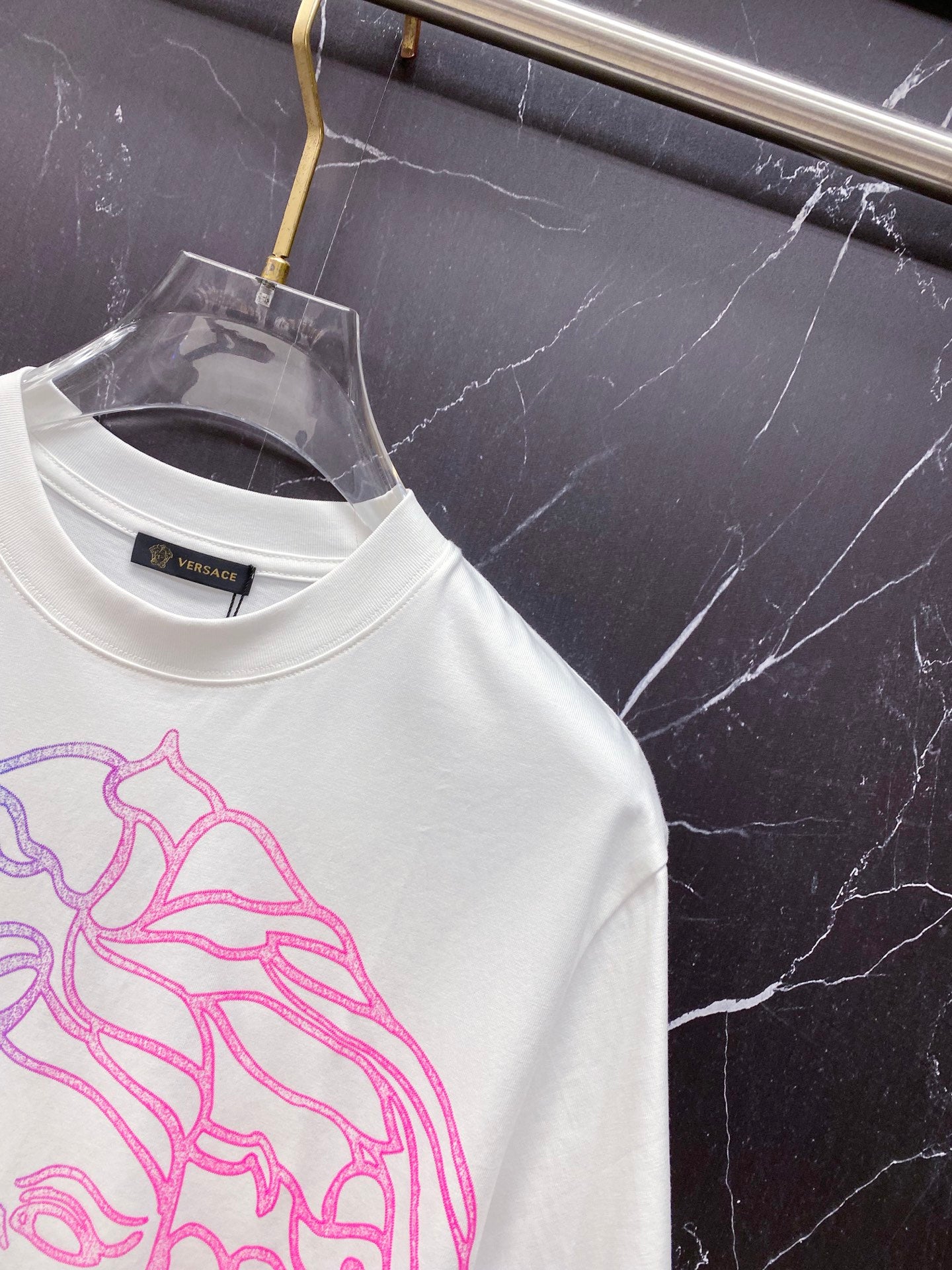 White T-shirt close-up of crew neck and inner brand label.