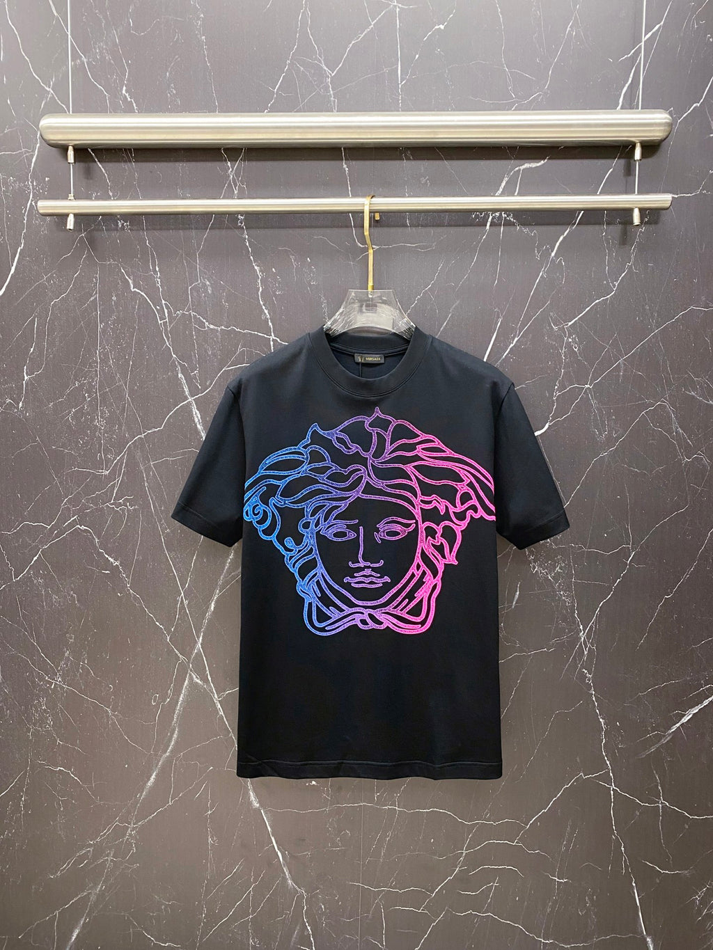 Black graphic T-shirt with neon blue and pink Medusa face front