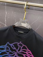 Black T-shirt neckline and neon blue/pink Medusa face graphic