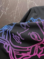Black T-shirt close-up of neon blue and pink line-art Medusa head