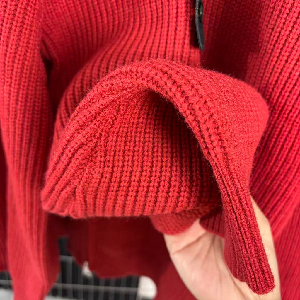 Red knit sweater sleeve and cuff with high collar zipper edge detail