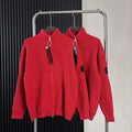 Red knit zip-up sweater with high collar, front zipper, hanging tags on rack