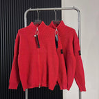 Red knit zip-up sweater with high collar, front zipper, hanging tags on rack