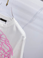 White crewneck T-shirt with black logo tag and blue/pink graphic