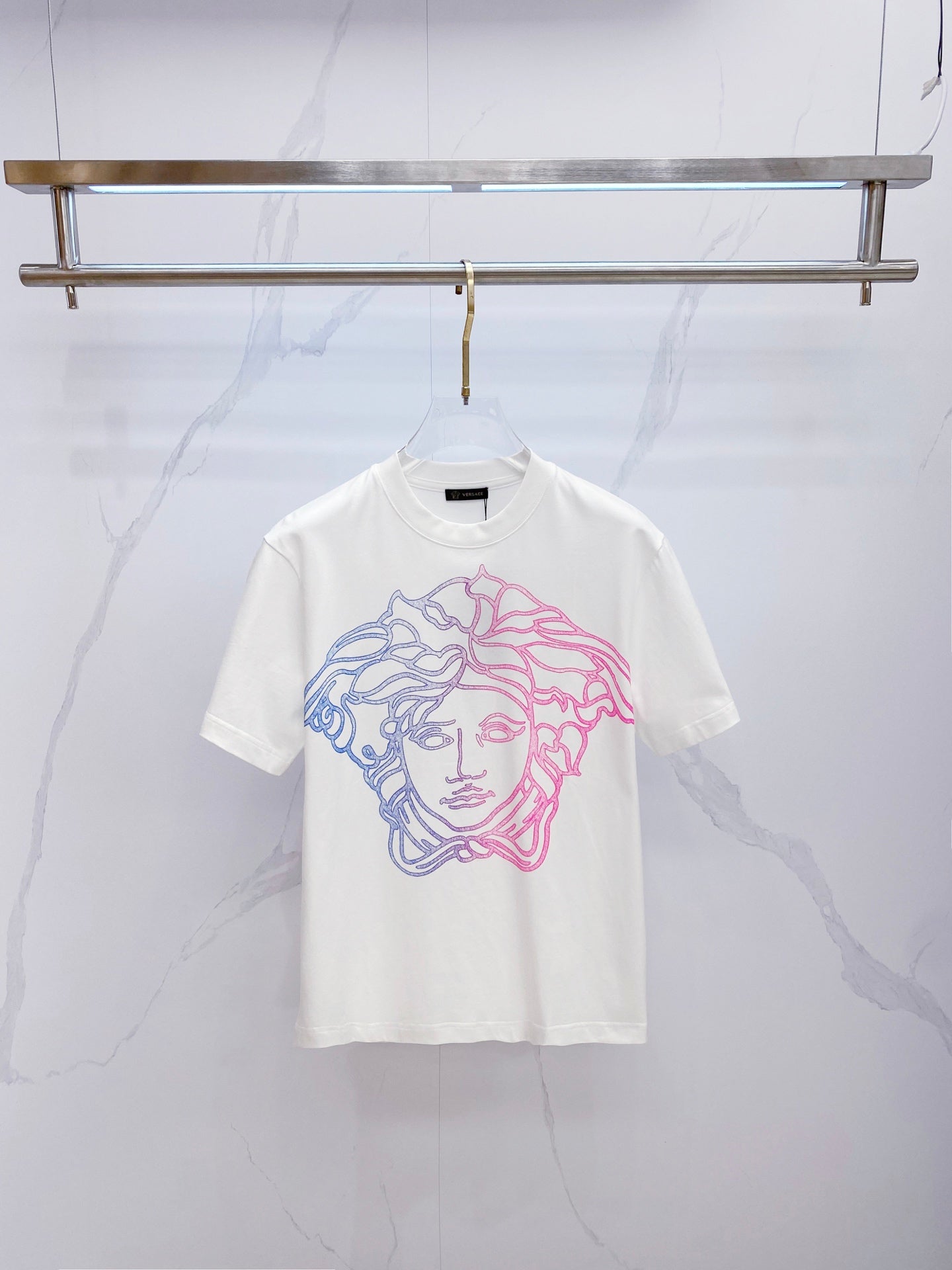 White crewneck T-shirt with blue and pink Medusa face graphic