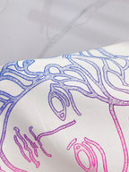 White T-shirt close-up of blue and pink Medusa line graphic