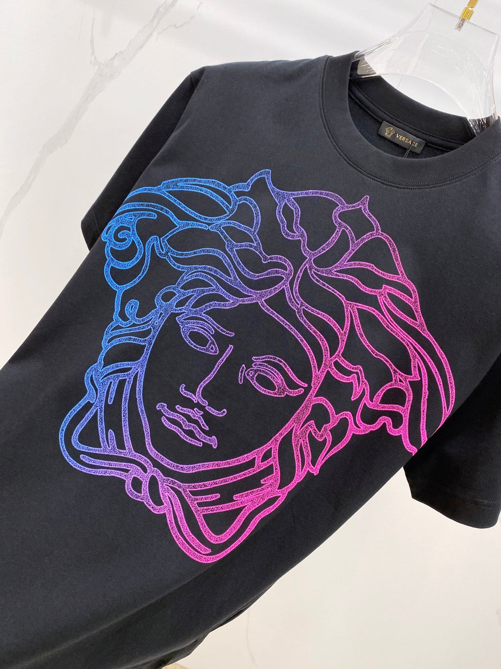 Versace T-shirt in dark navy with large blue, purple, and pink face graphic