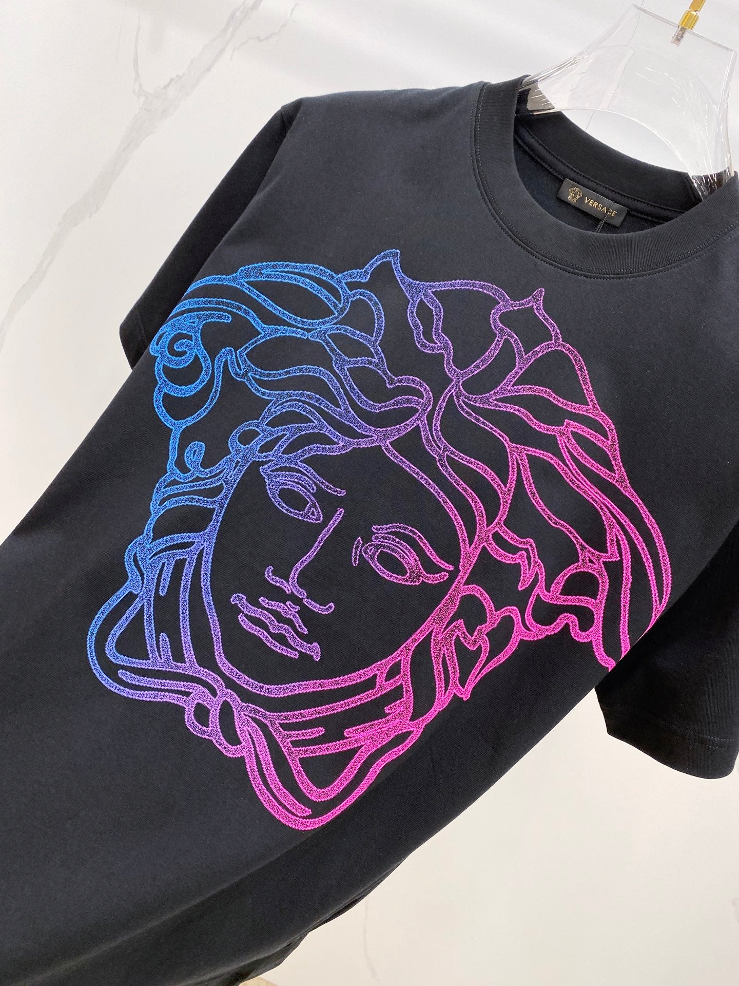 Versace T-shirt in dark navy with large blue, purple, and pink face graphic