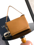 Tan leather shoulder bag with adjustable strap and flap front