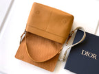 Tan leather mini bag with top flap, drawstring pull and crossbody strap