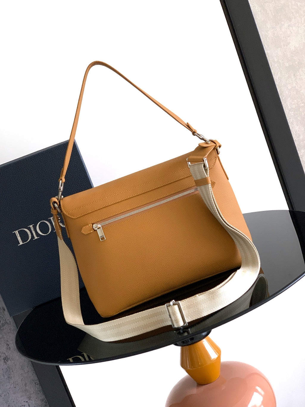 Tan leather shoulder bag with flap and zip pocket front, white strap detail
