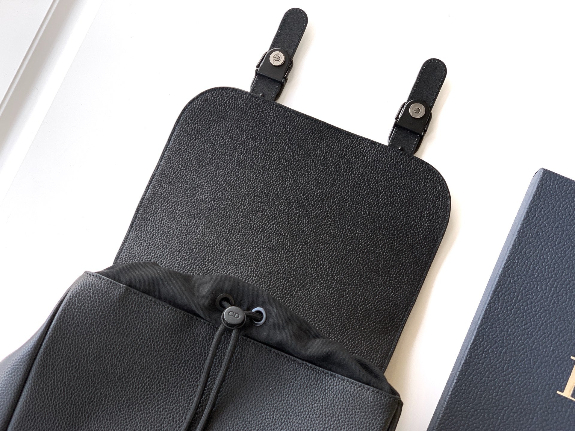 Dior backpack bag top section with two handle straps and drawstring detail