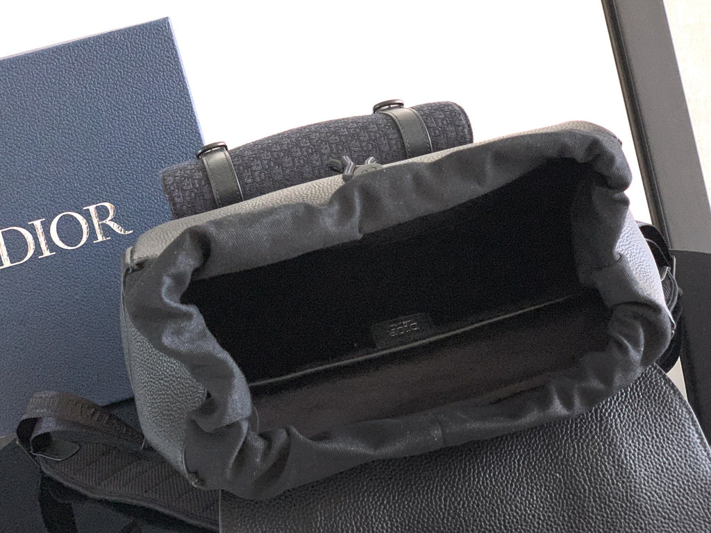 Dior backpack with open top and fabric lining, showing the main compartment interior.