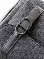 Dior backpack bag close-up of metal D-ring buckle on textured strap
