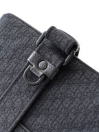 Dior bag strap detail with metal D-ring buckle on dark gray textured fabric.