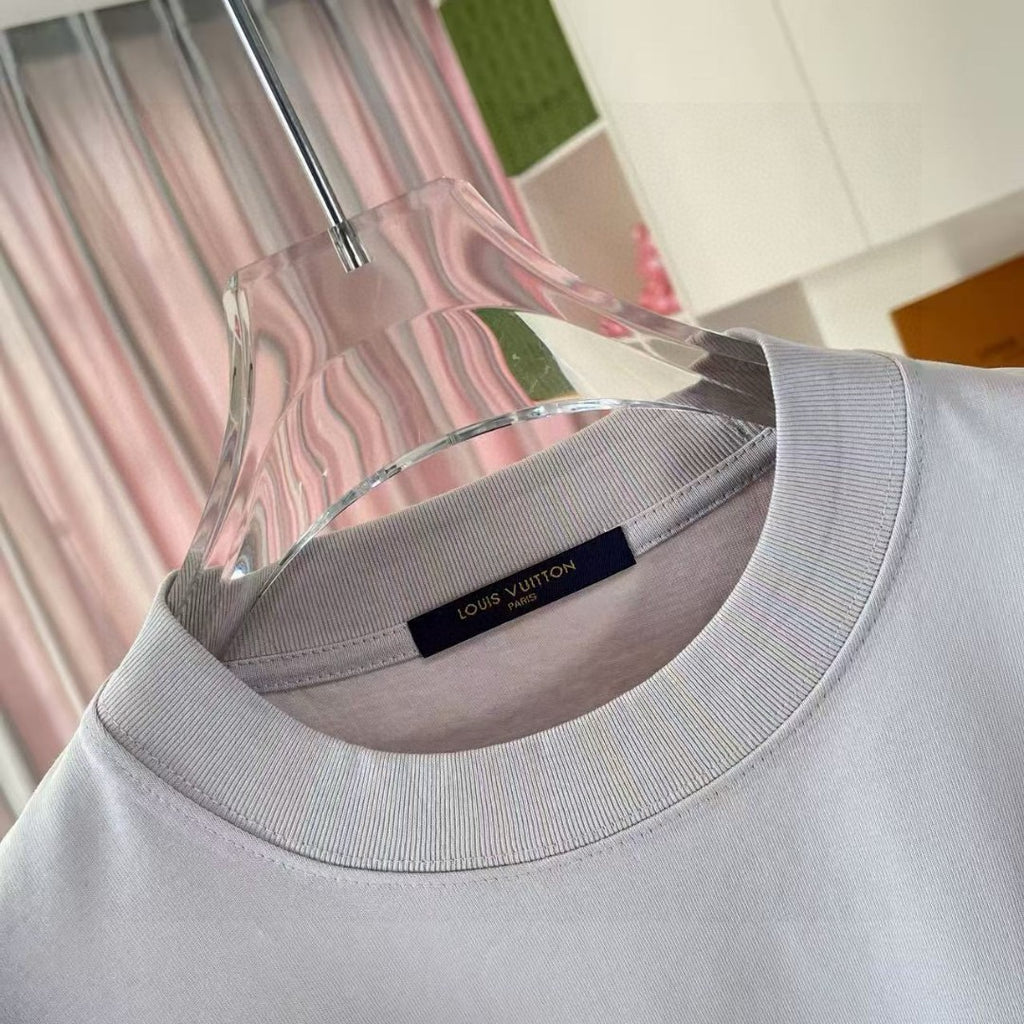 Light gray ribbed crewneck T-shirt with small interior label near collar