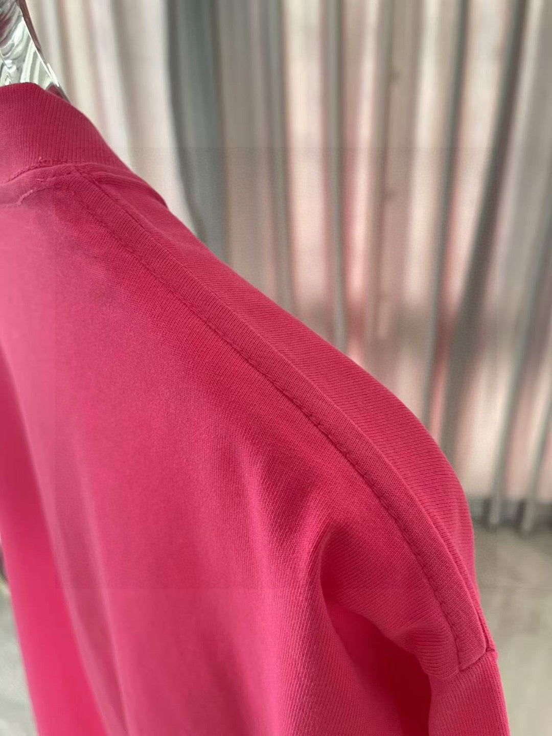 Louis Vuitton T-shirt sleeve close-up in bright pink knit fabric