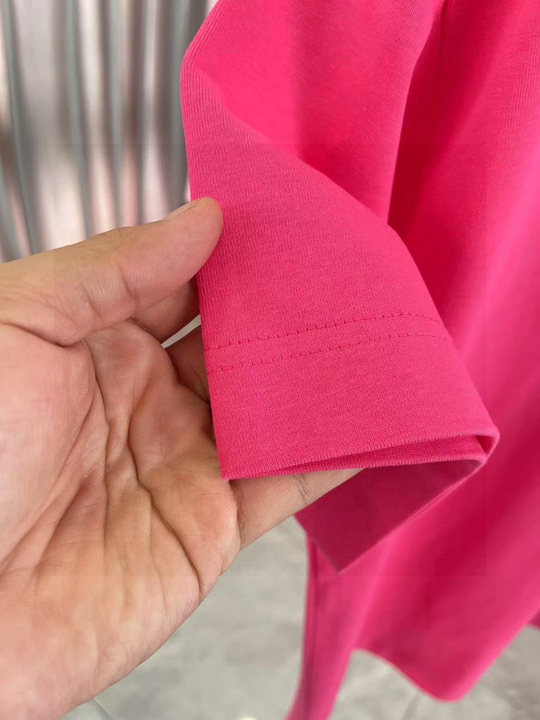 Louis Vuitton T-shirt hem close-up in bright pink with stitching detail