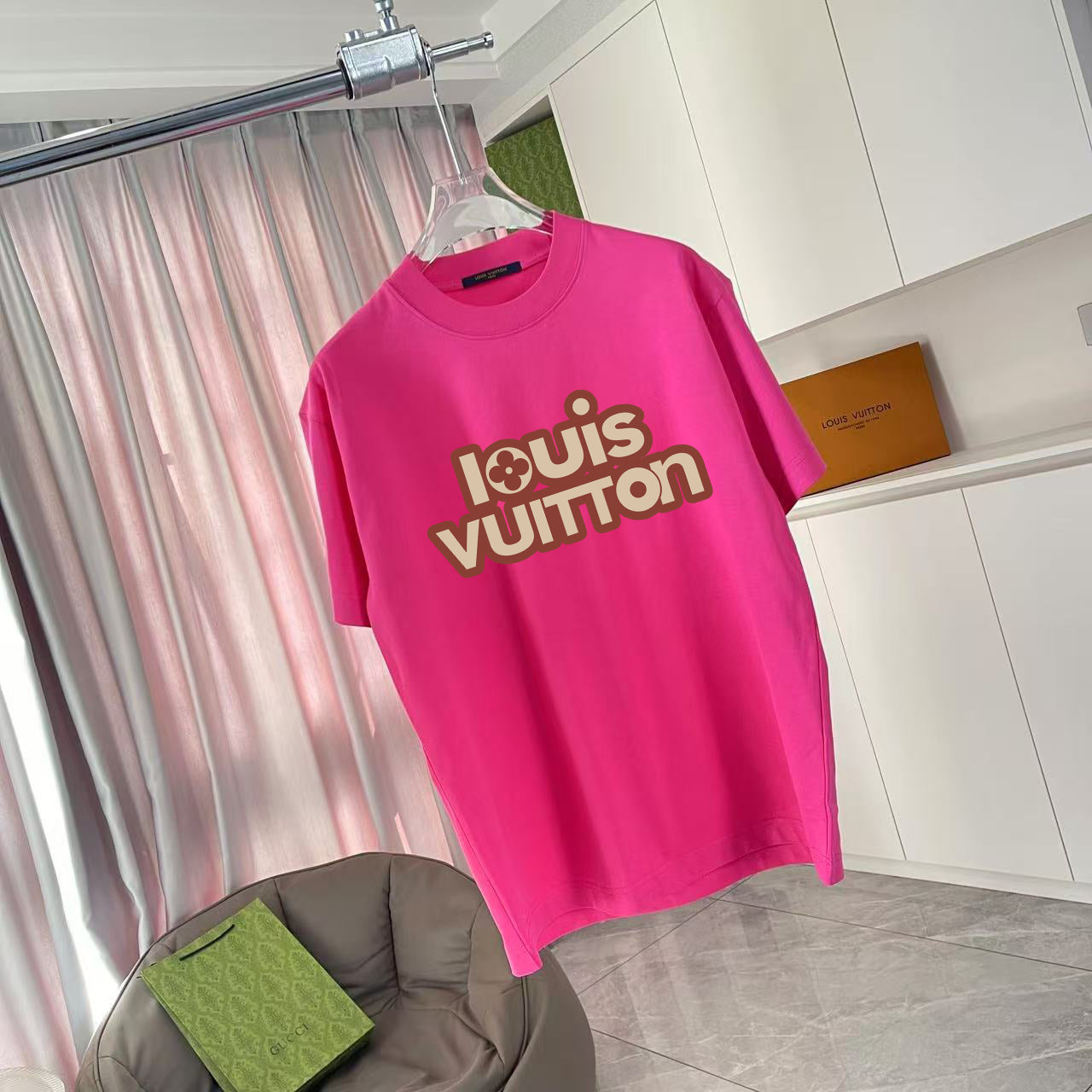 Louis Vuitton pink T-shirt, angled view with Louis Vuitton logo