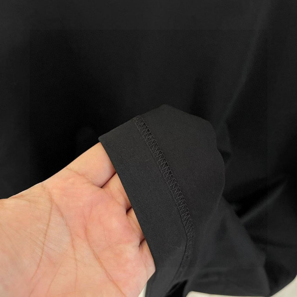 Black T-shirt fabric and sleeve edge close-up
