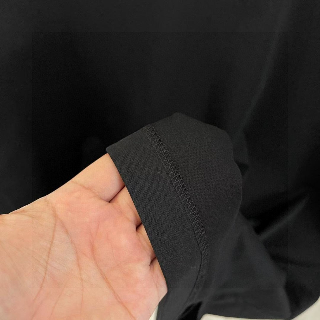 Louis Vuitton T-shirt hem detail, black fabric with subtle logo embossing