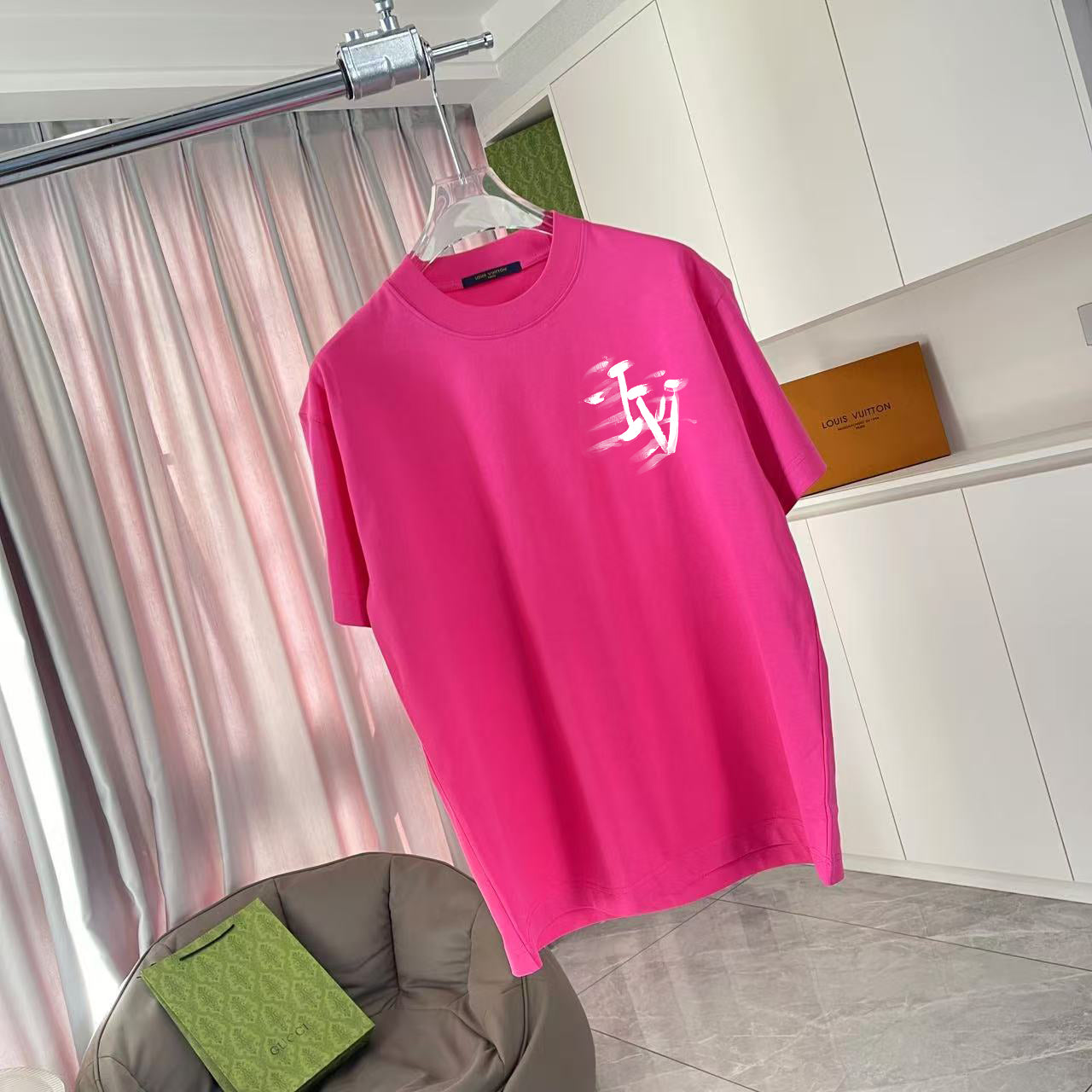 Louis Vuitton pink T-shirt on hanger, white logo graphic on front