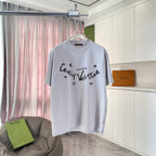 Light gray T-shirt with logo script print and star-and-flower motifs