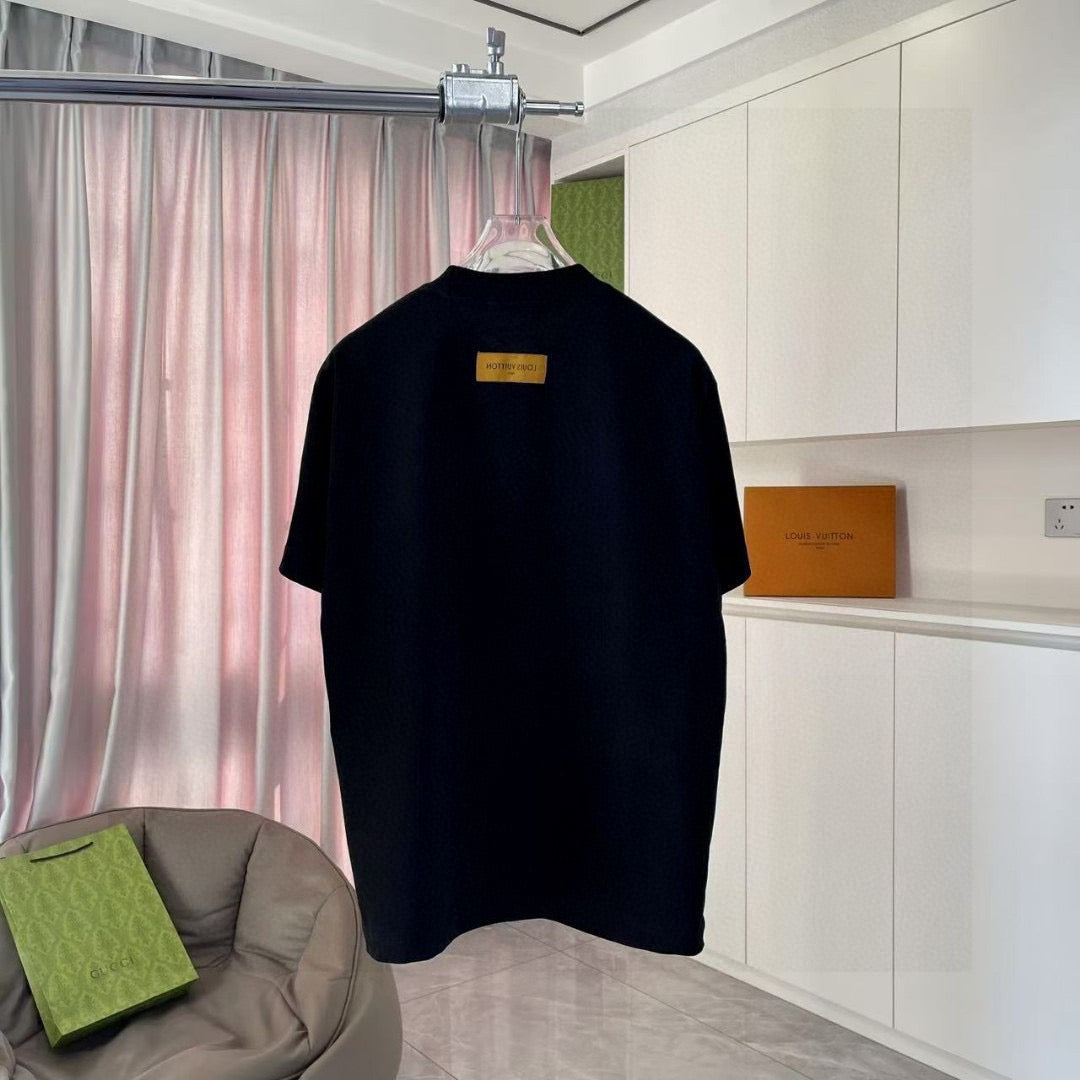 Black T-shirt back view with small yellow label at center