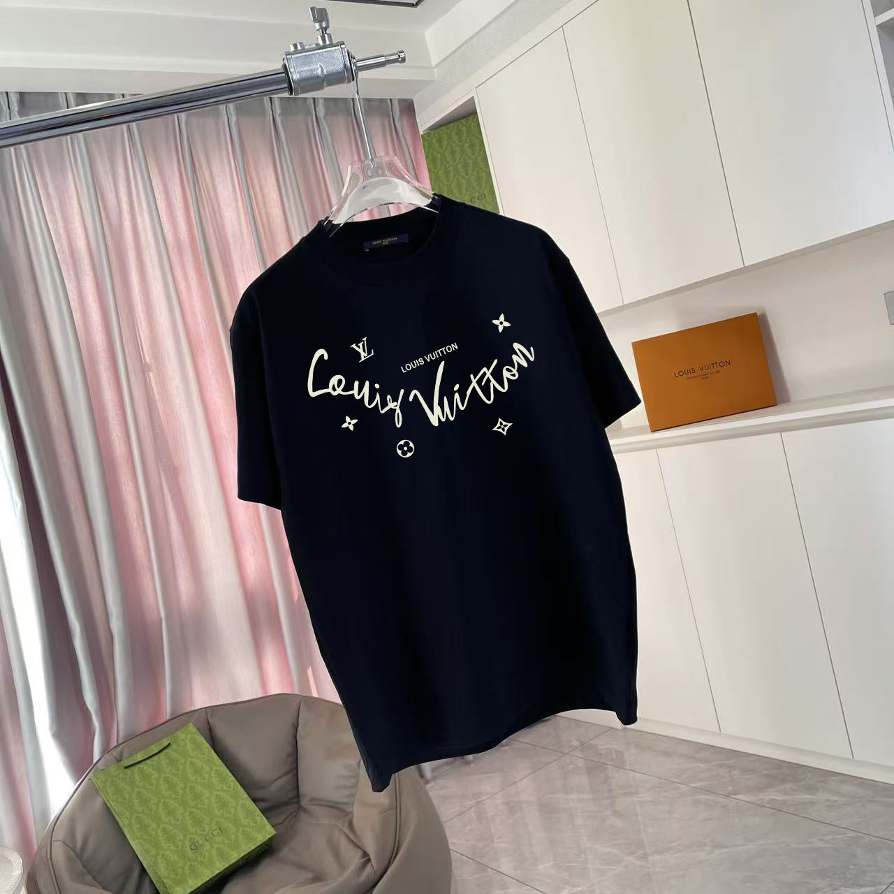 Louis Vuitton T-shirt, black, front graphic with gold script and flower-star motifs