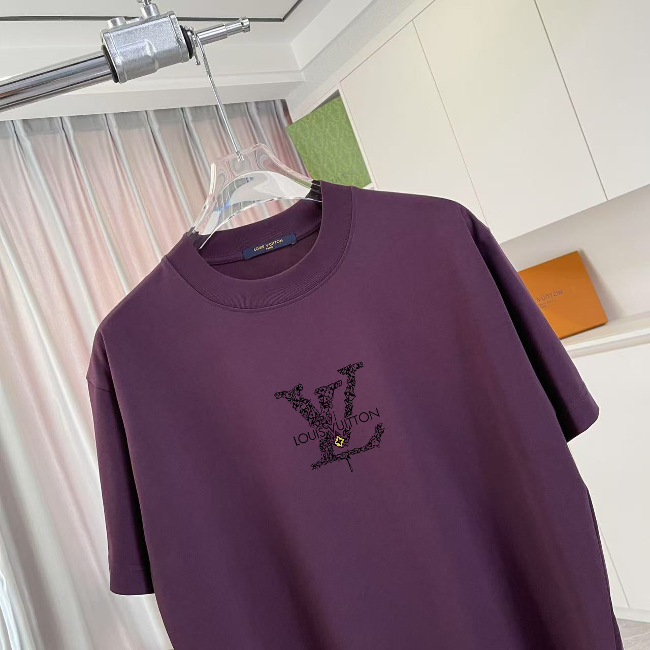Louis Vuitton T-shirt close-up: dark purple crew neck and chest graphic