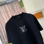 Black T-shirt close-up of embellished Louis Vuitton logo graphic