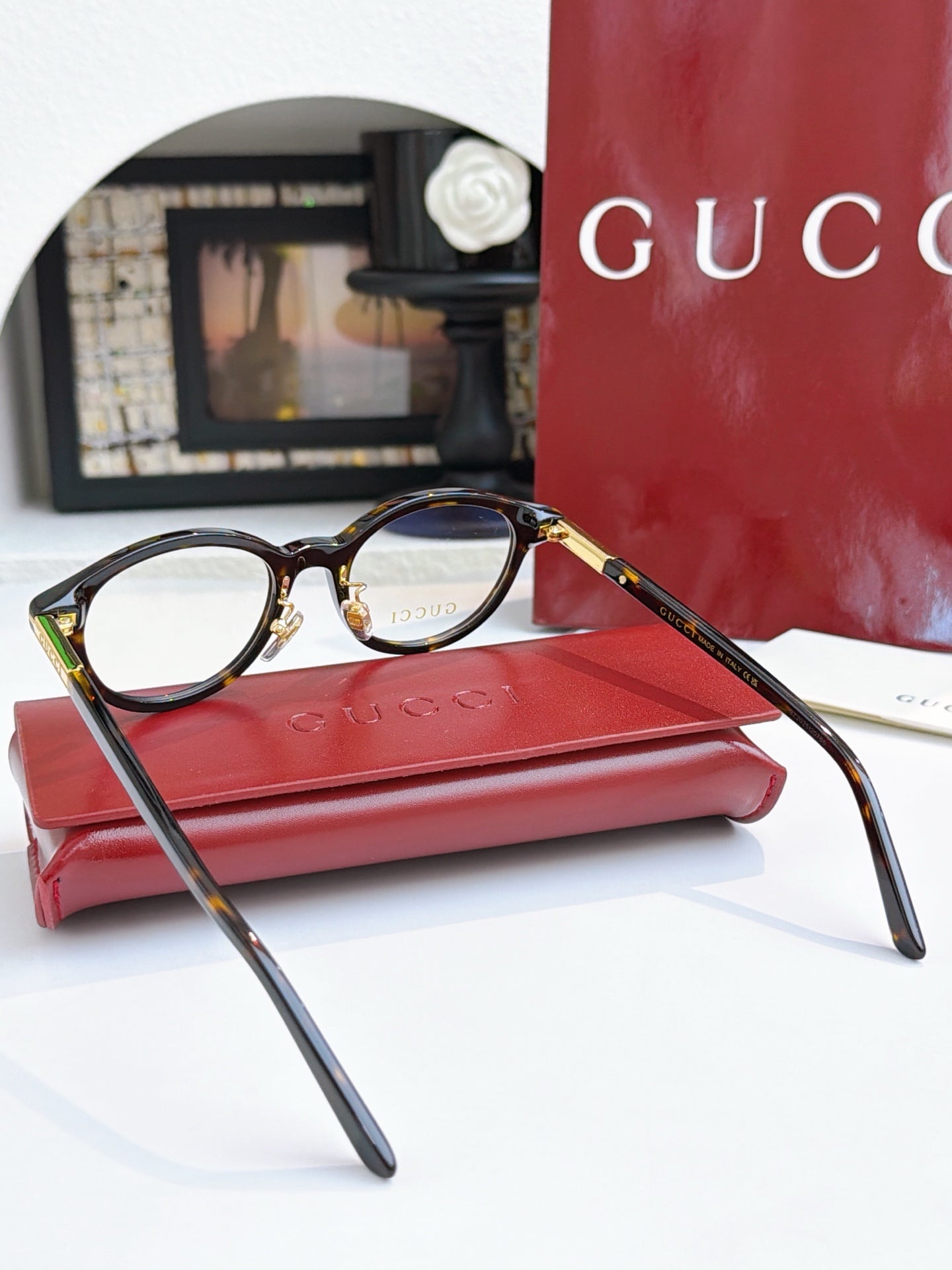 Gucci eyeglasses, black frames with blue lens tint; angled side view