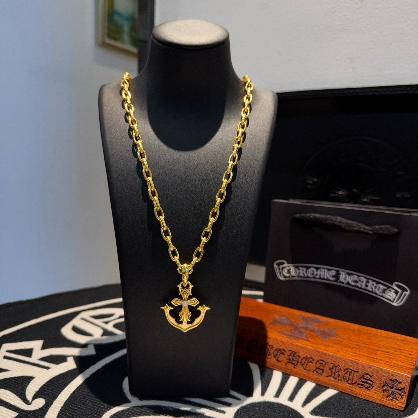 Gold-tone necklace with anchor pendant and curb-link chain