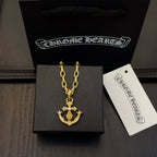 Gold-tone anchor pendant necklace with tag in black gift box