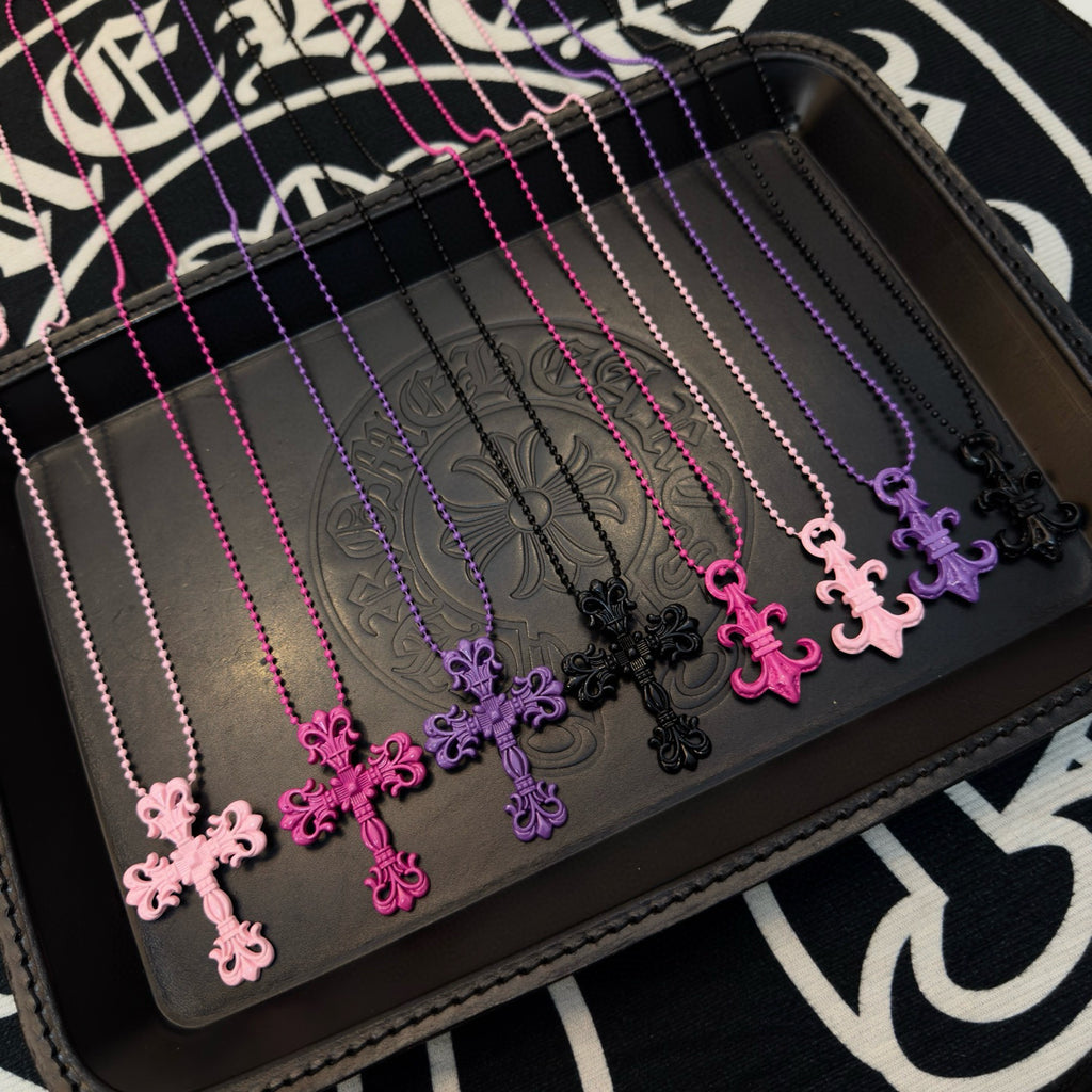 Ornate cross necklace with pink and purple bead chains and floral cross pendants
