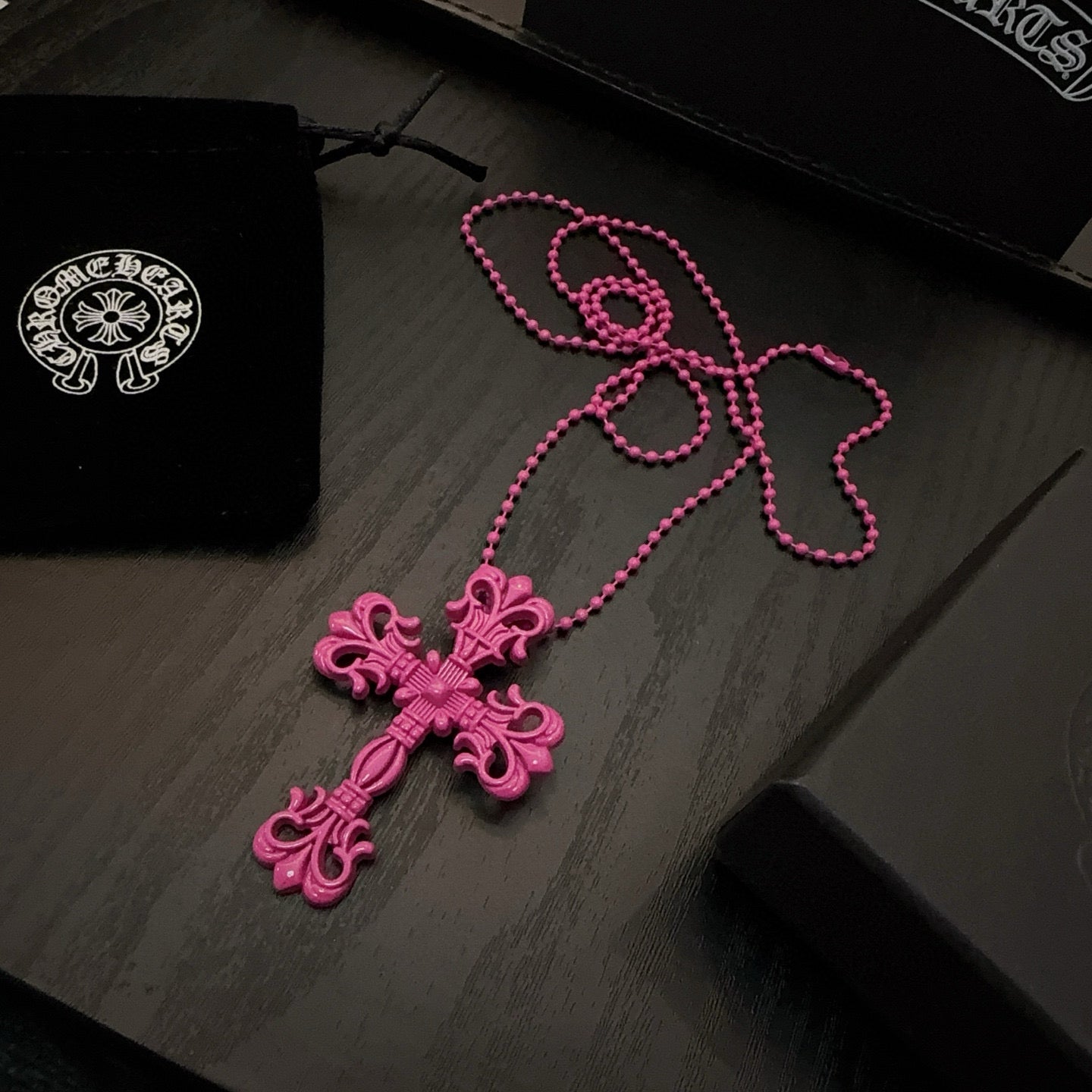 Ornate floral cross necklace with pink bead chain and magenta cross pendant
