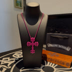 Pink beaded cross necklace with floral cross pendant on dark bust mannequin
