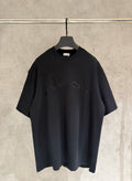 Black short-sleeve T-shirt with crew neck and embroidered graphic on chest.