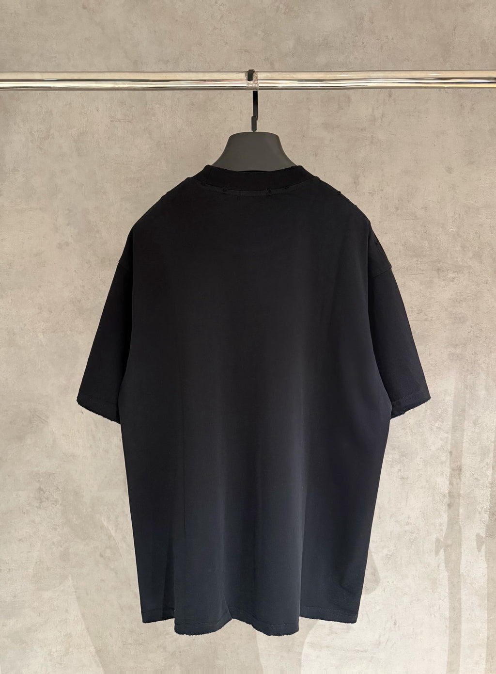 Black short-sleeve T-shirt, back view with relaxed fit.