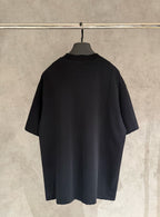 Black short-sleeve T-shirt, back view with relaxed fit.